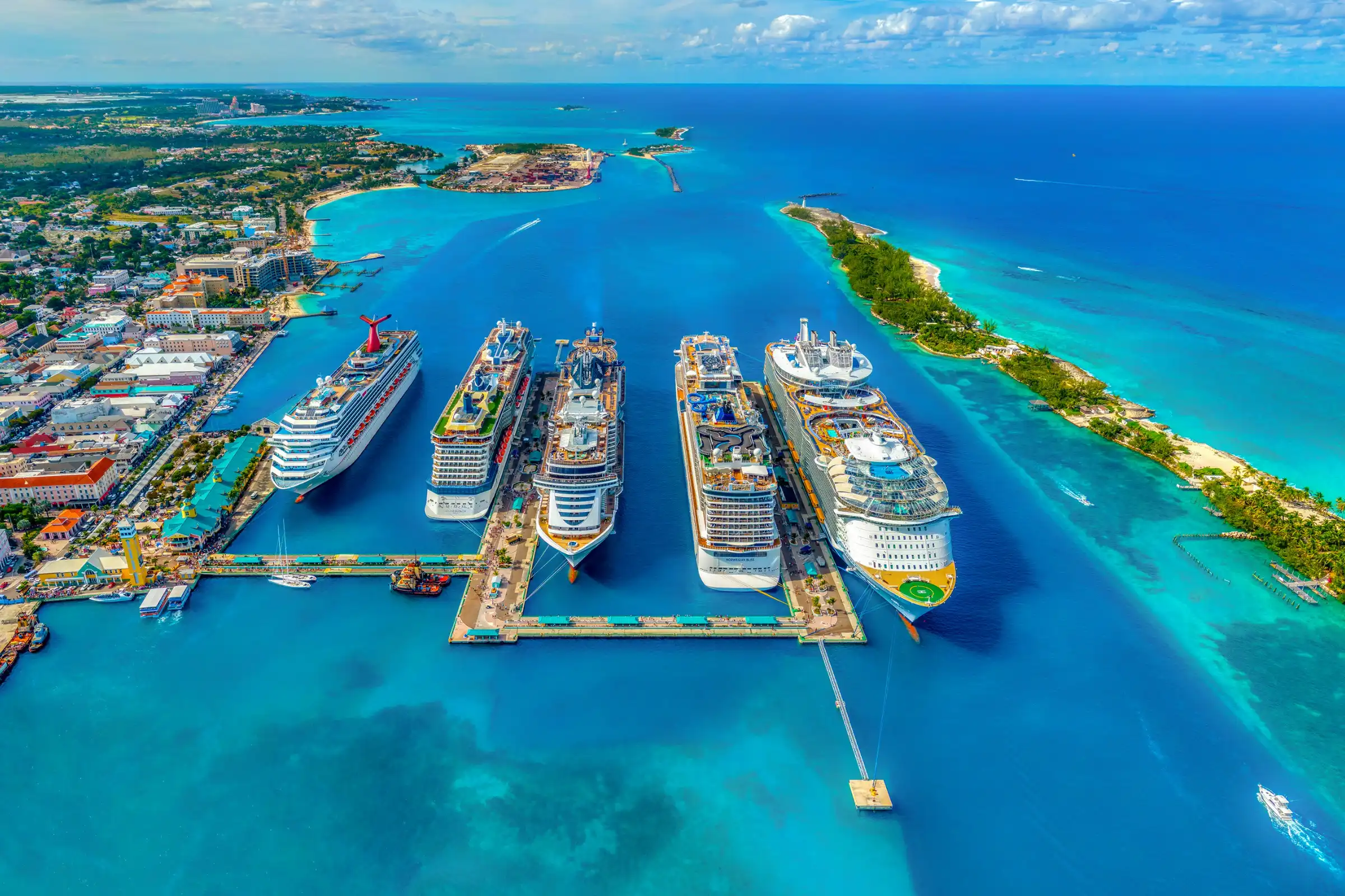 a photo of five cruise ships docked in port