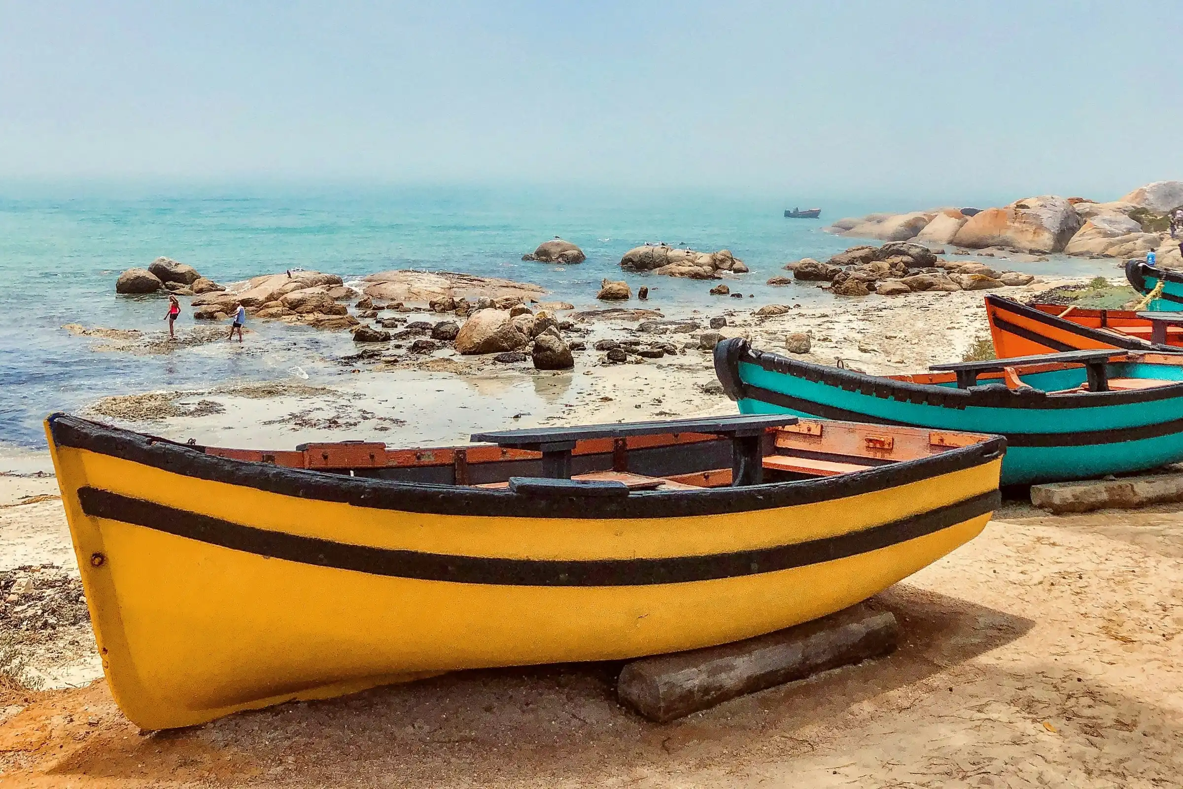 a photo of small wooden boats along the mediterranean coast