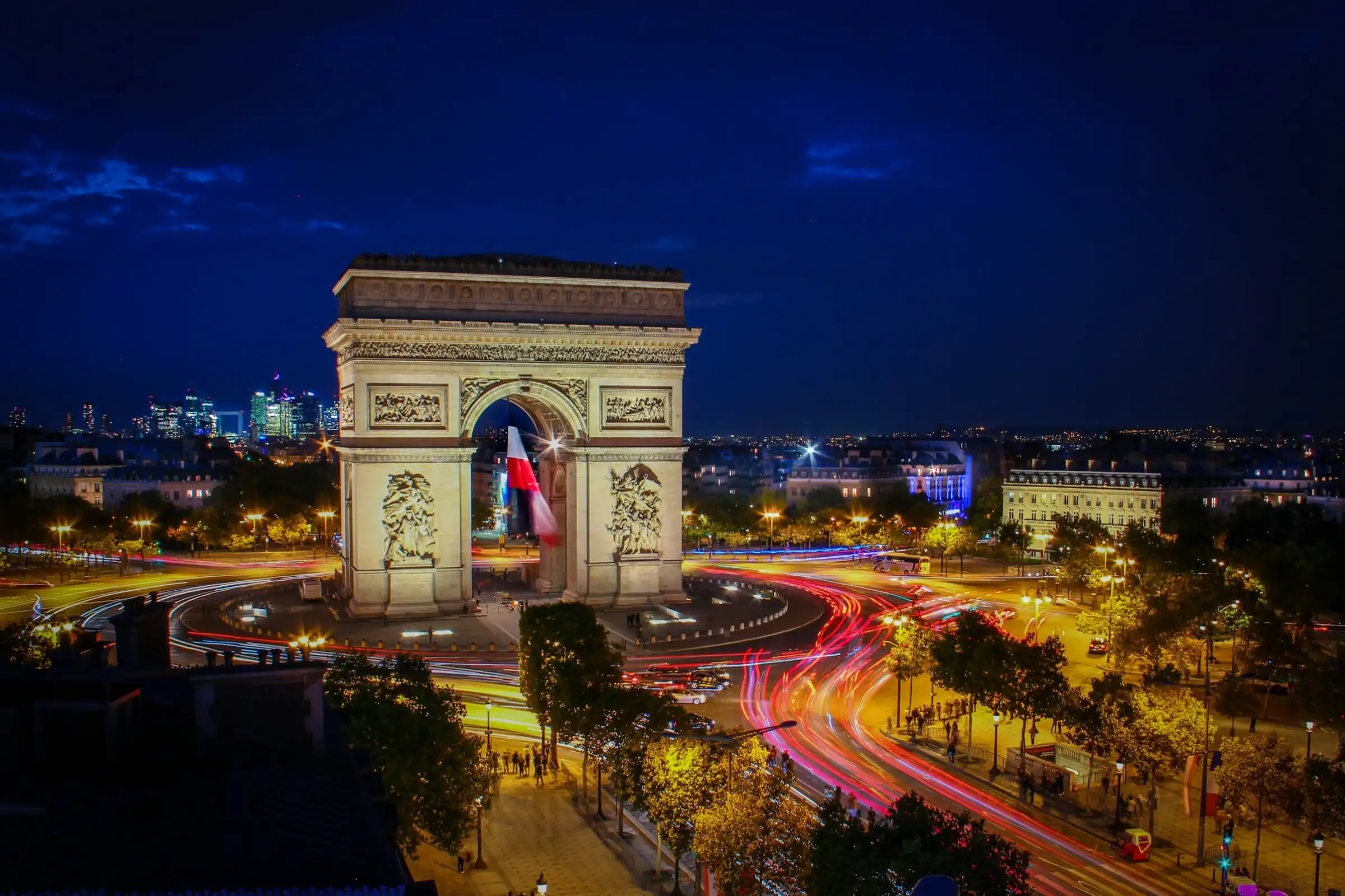 A nightime photo of the Arc de Triomphe in Paris